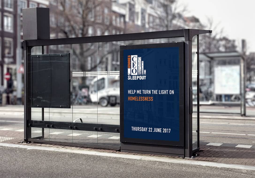Bus shelter with a blue poster promoting the CEO Sleepout event to raise awareness of homelessness, dated June 22, 2017.