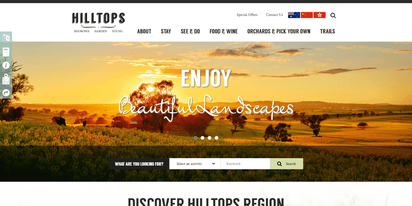 Sunset over rolling hills and fields with scattered trees in the Hilltops region.