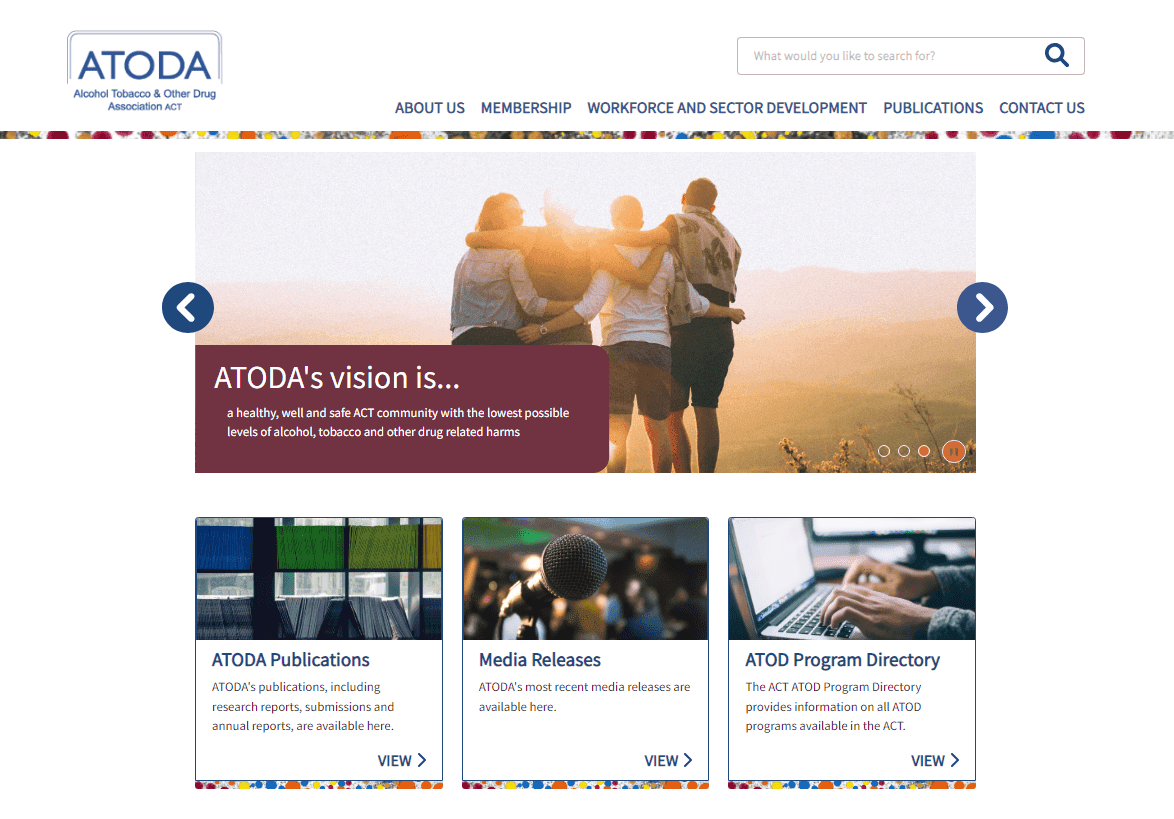 Website homepage of ATODA showing vision statement with people embracing at sunset and navigation options.