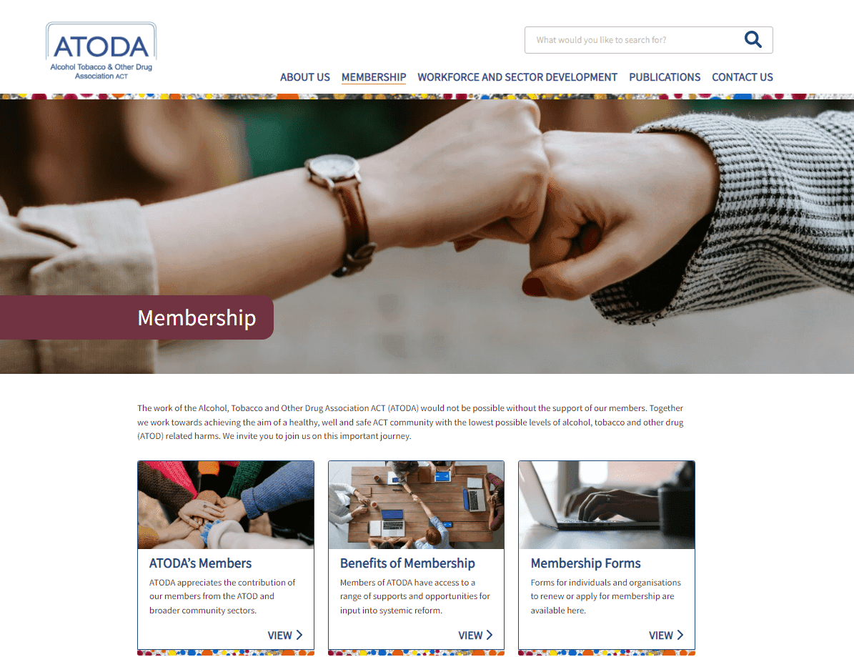 Two people giving a fist bump above a webpage section titled "Membership" on the ATODA website.