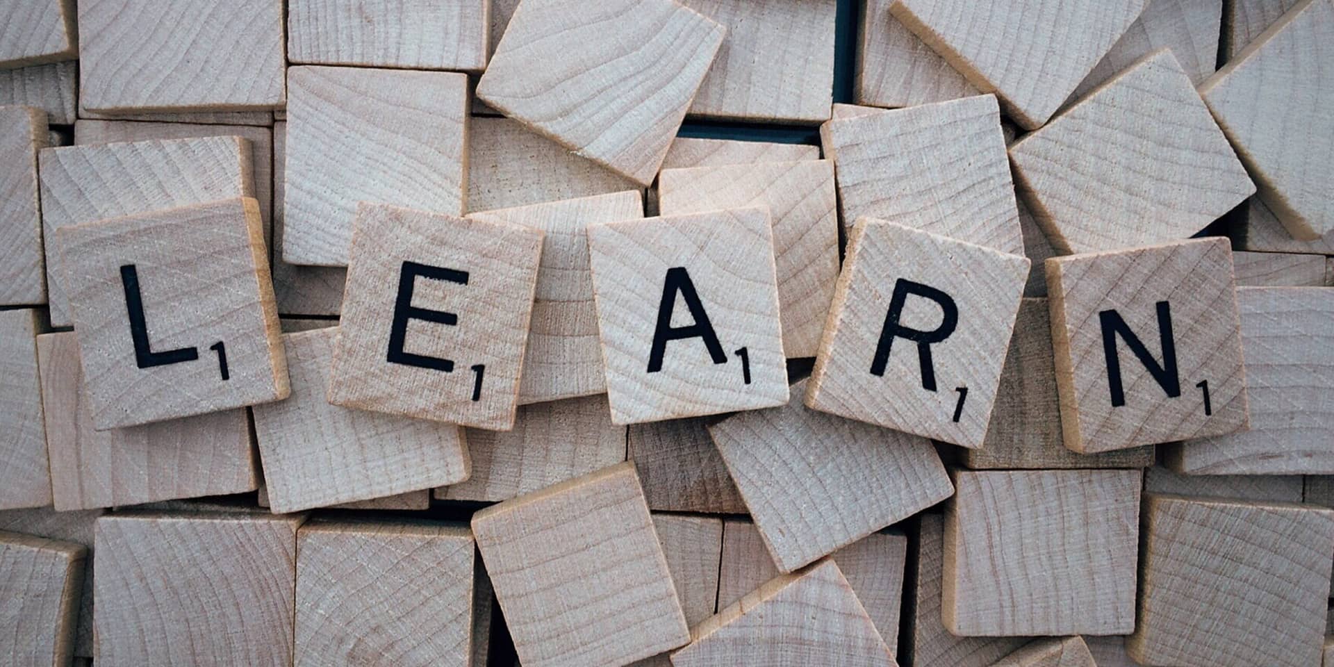 Scrabble tiles spell "LEARN" on blank tiles, showcasing the importance of big data analytics in education.