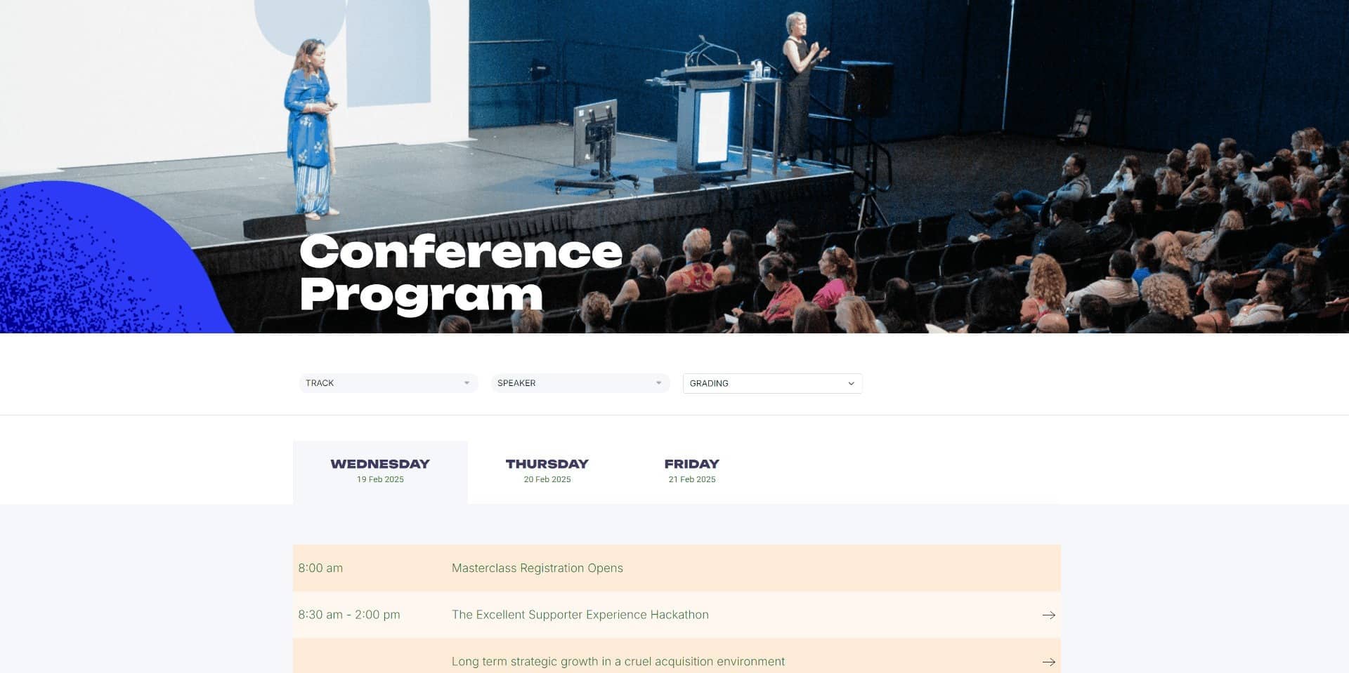 Audience seated and two speakers presenting on stage at a conference with a program schedule.