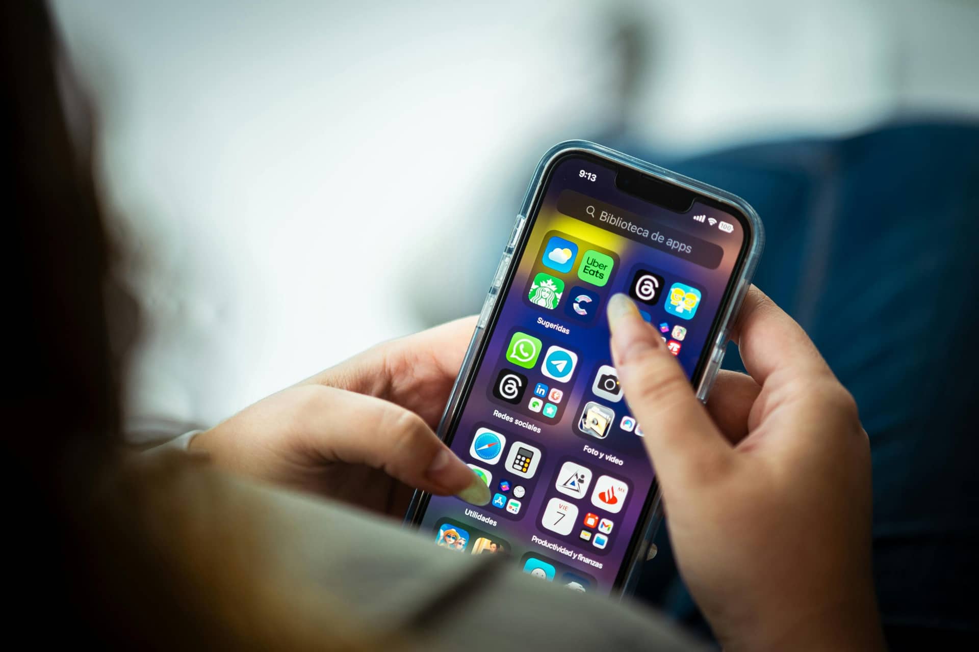 iOS app development company showcasing a vibrant app library on a smartphone screen, featuring social and utility apps.