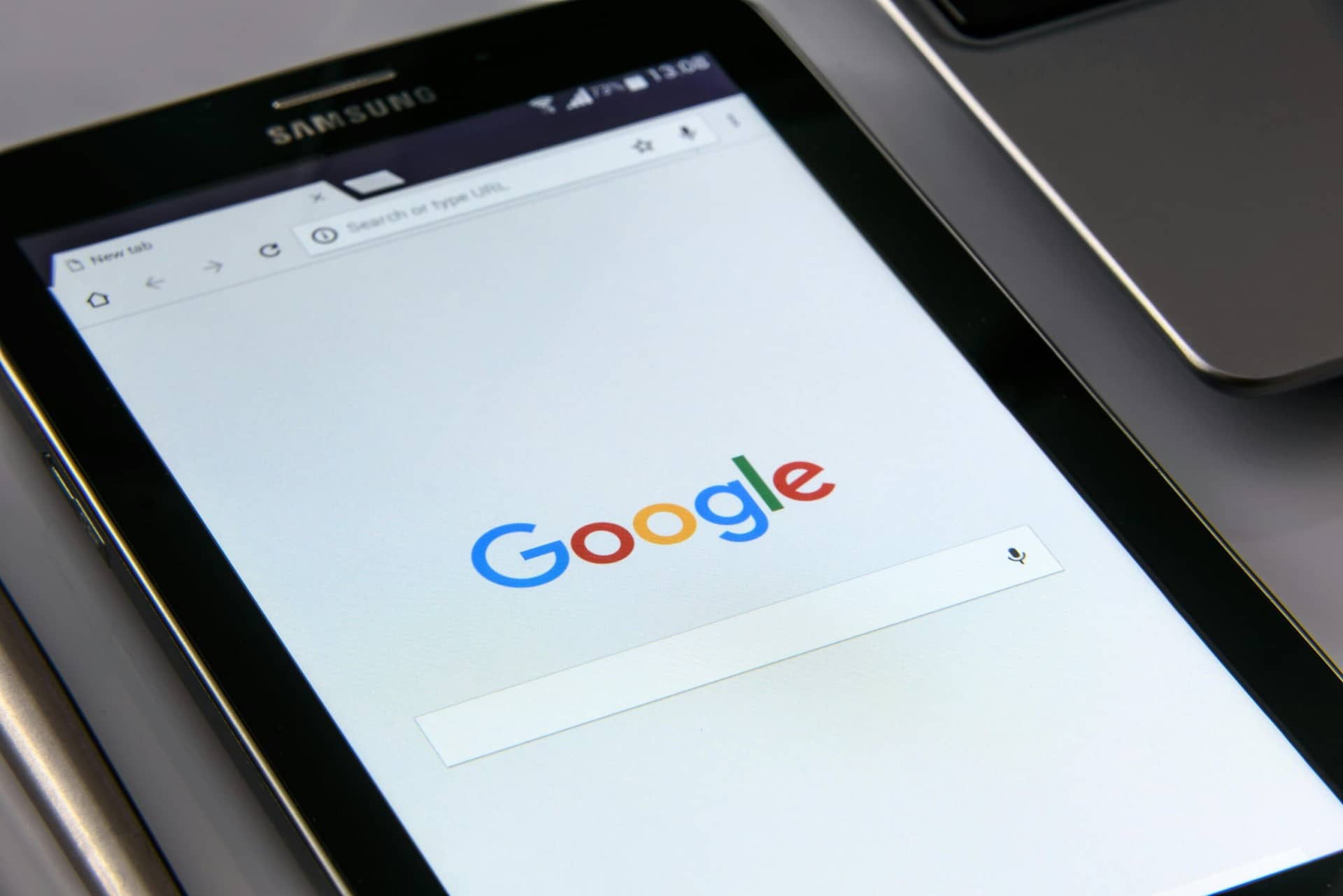 Samsung tablet displaying Google search homepage with empty search bar and voice search icon, showcasing headless CMS feat...