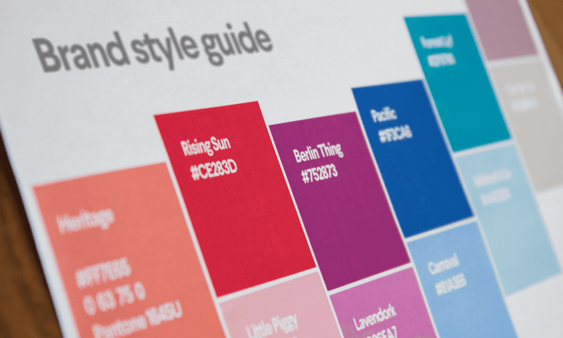 Close-up of brand style guide with color swatches and hex codes for design reference, showcasing brand style guide examples.