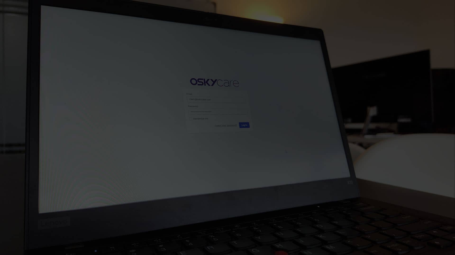 OSKYcare login page with email and password fields for website security and health check, featuring "Log In" button.