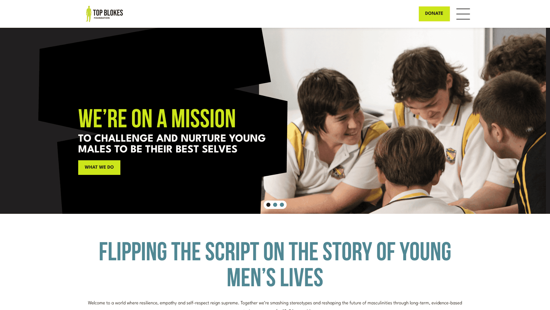 Group of young males in school uniforms smiling and engaging in a discussion.